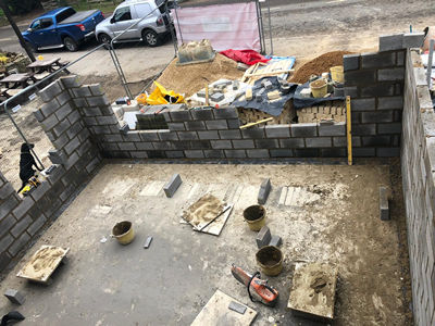 Ext. Day. Pub. High–angle view of the well-advanced blockwork