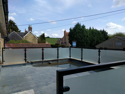 Ext. Day. Pub. The Edge Protection on the Flat Roof has been completed.