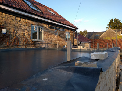 Ext. Day. Pub. A fibreglass and liquid waterproofing process laid onto the flat roof