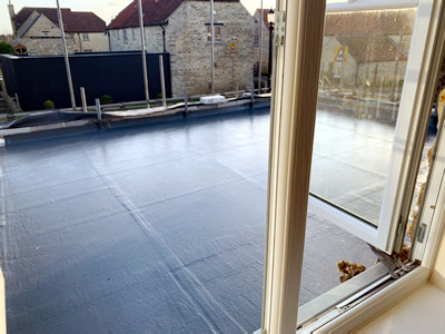 Ext. Day. Pub. A fibreglass and liquid waterproofing process laid onto the flat roof