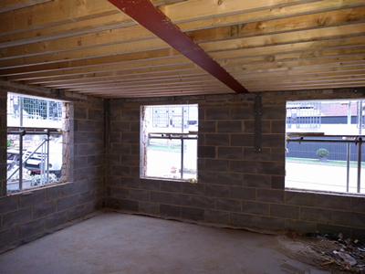 Int. Day. Pub. Interior of the room looking South East. The floor to the flat roof has been boarded.