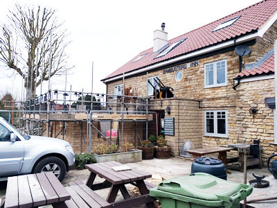 Ext .Day. Pub. Scaffolding erected around the three walls