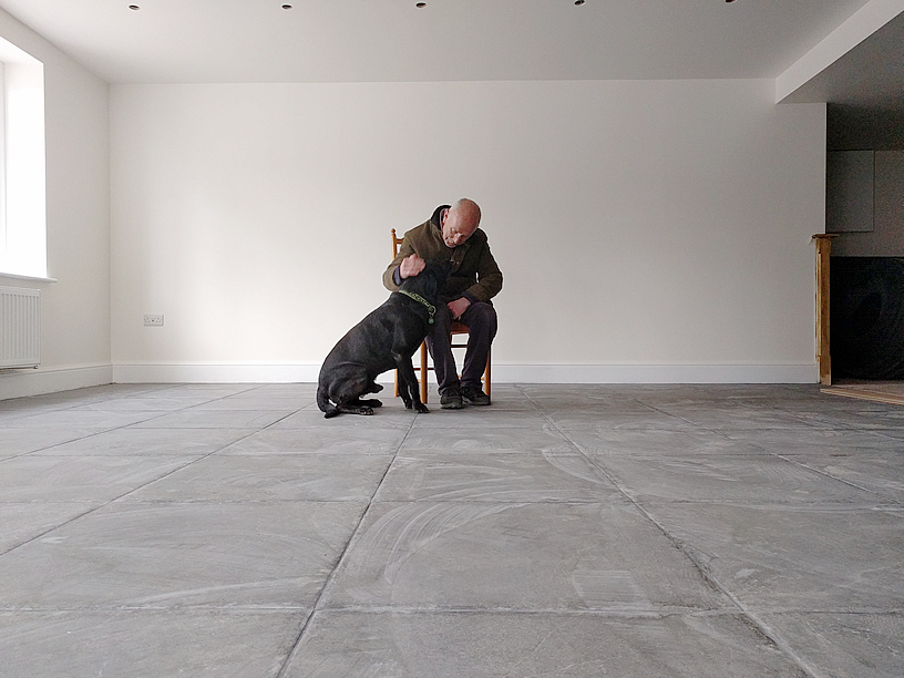 Int. Day. Pub. Greg Algar (seated) and his Labrador dog, Bomber, trying out the new floor.