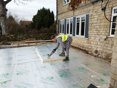 Ext.Day. Pub. Floor insulation being hand–sawn and cut to size